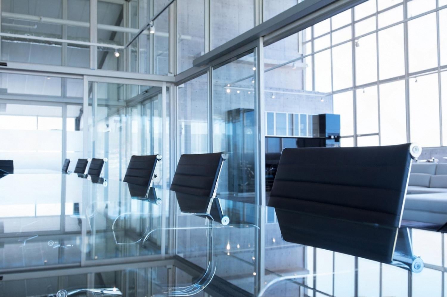 Empty glass-walled boardroom in a modern UAE office, symbolising a company with no visible information